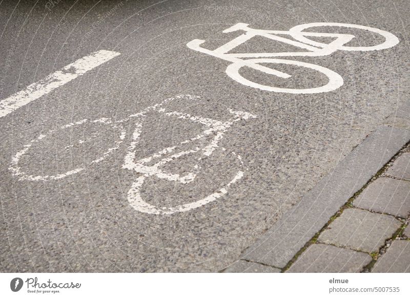 old and new pictogram of a bicycle, standing at 90 degrees to each other, indicate a bicycle lane on the road Cycle path cycle path Bike lane ride a bicycle