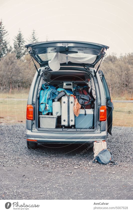 Close up of a van filled with suitcase, bag and road trip stuff ready to start the route traveling across iceland. Sleeping outdoors, camping and exploring concepts. Copy space Image.