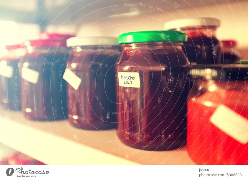 Grandma's jam from 2022 in preserving jars on shelf Jam Cherry jam cherry Jam jar Preserving jars Cellar Supply Glass Food Self-made Organic produce Close-up