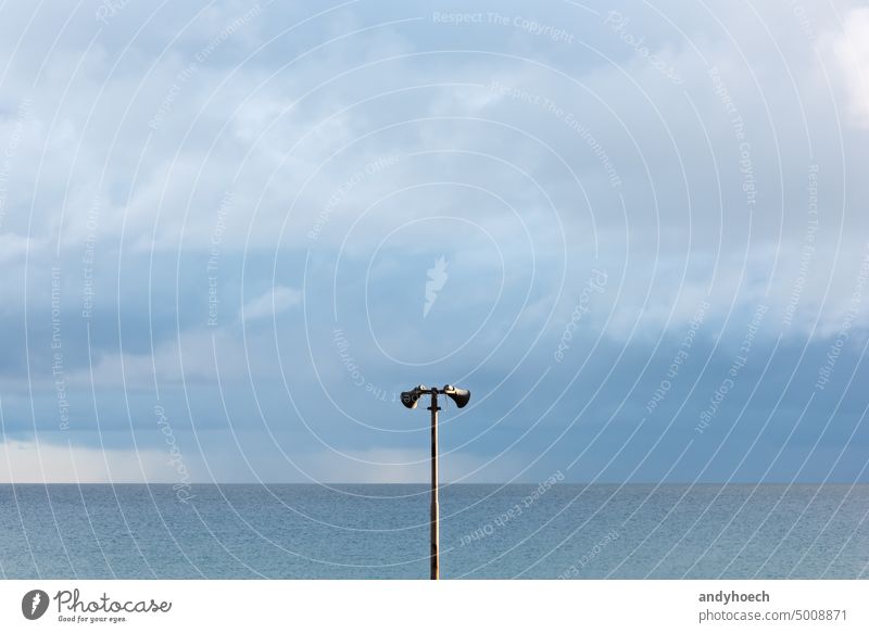 Two speakers on a sunny evening by the sea advertisement alert announce announcement attention bullhorn clean coast communicate communication copy space danger