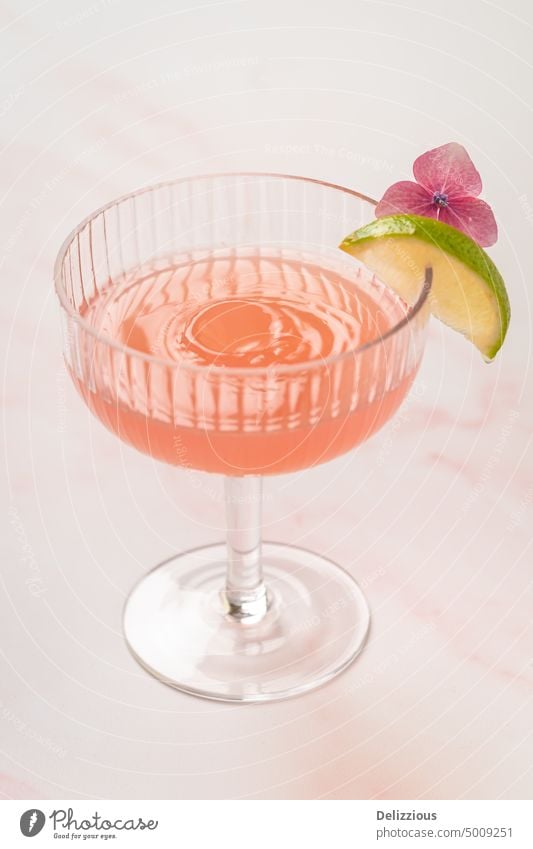 A pink cocktail drink with a splash droplet in the glass lime flower drinks mocktail tasty bar sweet alcohol drinking serve no people copyspace copy space