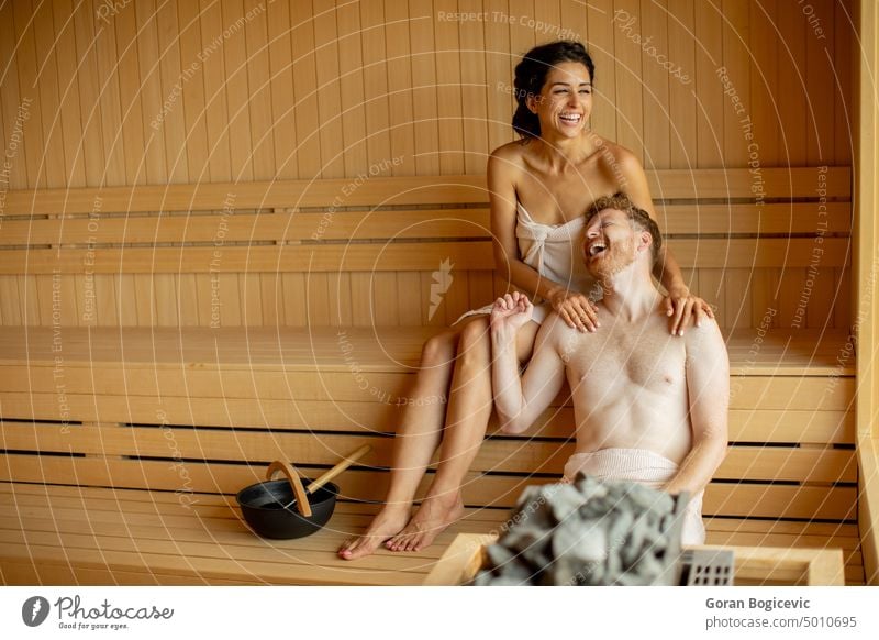 Young couple relaxing in the sauna adult attractive beautiful beauty body calm care caucasian comfortable enjoy enjoyment female fitness handsome happy health