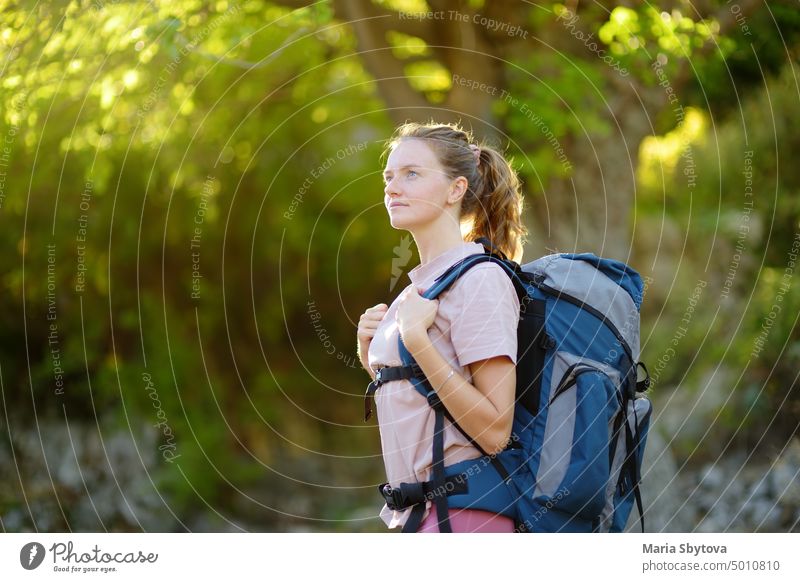 Young woman hiking in countryside. Backpacking hike backpacking trip single girl hiker solo female backpacker summer tourist south forest adventure tourism