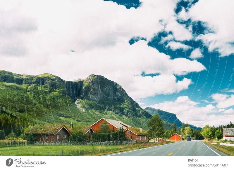 Norway, Road In Norwegian Mountains With Houses. Summer View. Sunny Day, Landscape With Rocks And Road trip tourism europe architecture nobody summer motorway