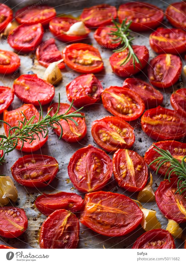Red heirloom tomatoes baked with garlic vegetable cook oil olive process oven tin parchment natural healthy eating red italian cherry food fresh harvest summer