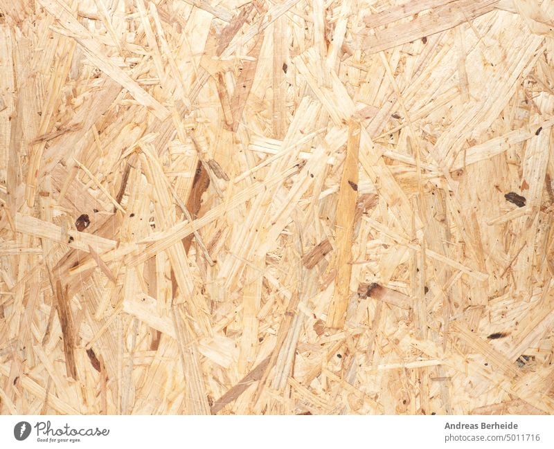 Texture of an osb board using as background panel chip wood recycle rough plank detail nature carpentry recycled building flat subfloor structure wall
