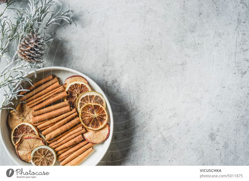 Plate with winter spices: cinnamon sticks, anise stars and dried orange slices, top view plate aroma aromatic background christmas cooking dry food healthy