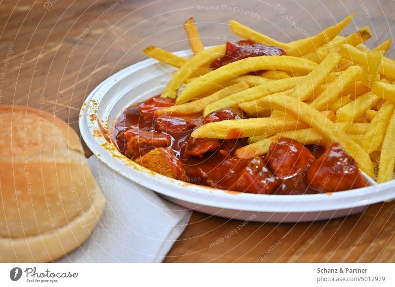 Curry sausage with fries and bun on a plastic plate Fast food Nutrition Food Eating Delicious Snack Unhealthy Snack bar French fries Ketchup Fat Hotdog Sausage