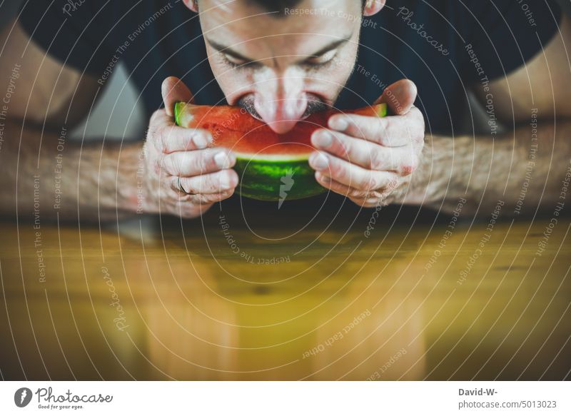 bite into a watermelon with pleasure Water melon fruit Eating pleasurably Bite vitamins Man Delicious Nutrition salubriously Mouth bite off Food Juicy Fitness
