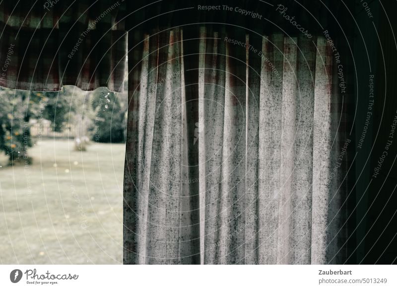 Garden view or observation, in front of it old curtain, in gloomy basic mood Looking Observe Hide Checkered frowzy Window Curtain Drape Cloth crease
