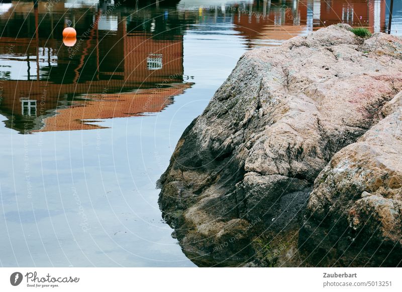 Red Norwegian wooden houses reflected in water, rocks in foreground, buoy Wooden houses Norway norwegian Scandinavian Water reflection Rock North coast Harbour