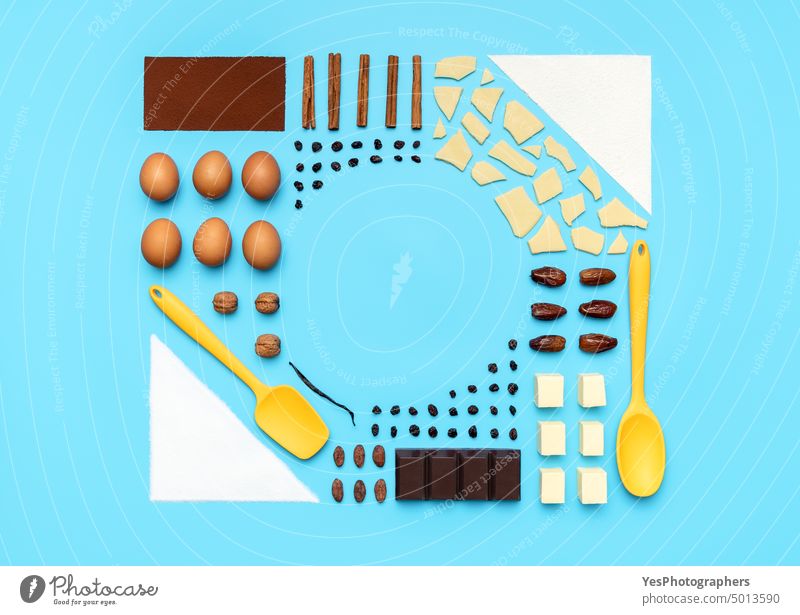 Baking ingredients and utensils, flat lay. Food knolling on a blue background above aligned arrangement baking butter cacao chocolate christmas color