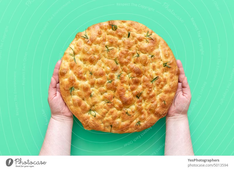 Focaccia with rosemary in woman hands, above view appetizer background baked bakery bread brunch close-up color crust cuisine delicious details flat focaccia