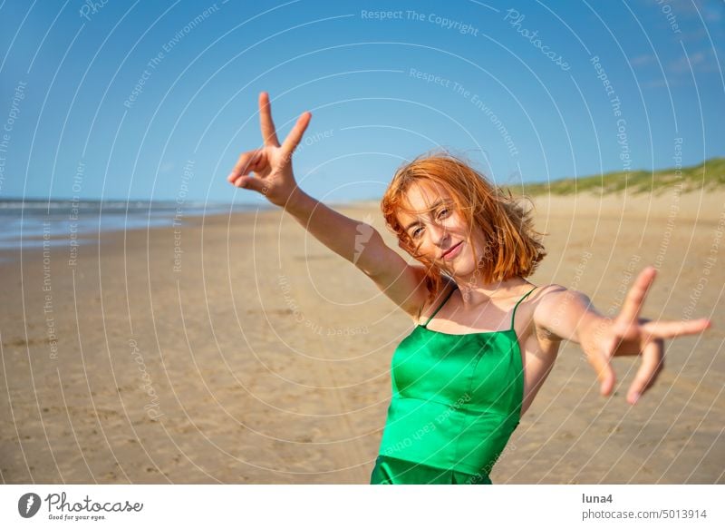 happy girl shows victory sign Girl Sign Beach gesture Sieg Success Gesture Ocean cheerful Laughter Happy teenager fortunate Dress Joy untroubled optimistic