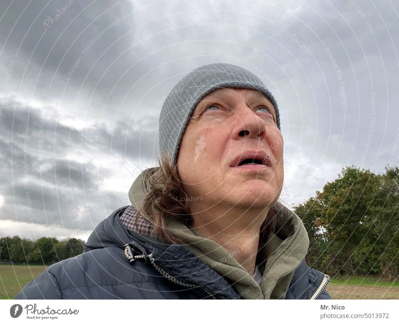 Questioning look at the sky Upward Man Observe Facial expression Meditative hope Looking asking Insecure Environment view into the sky Clouds Face Bad weather