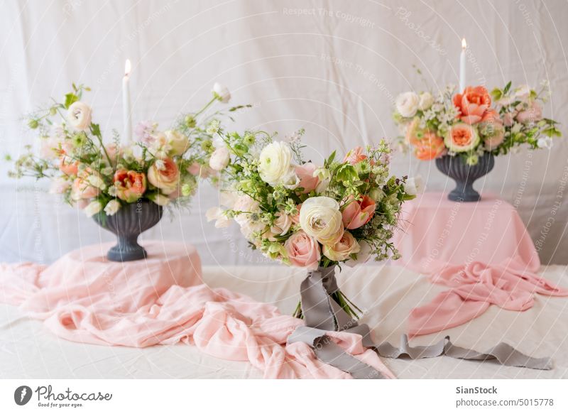 Still life with  beautiful bouquets of flowers and candles table vase wedding light soft decoration white background interior arrangement dinner romantic pink