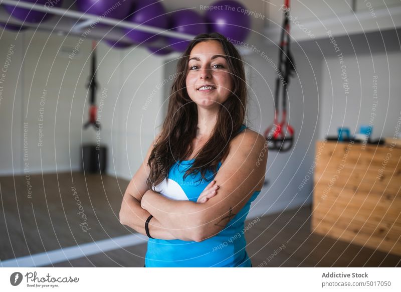 Smiling yoga instructor looking at camera in studio woman trainer smile positive healthy wellness fitness happy wellbeing practice female cheerful young