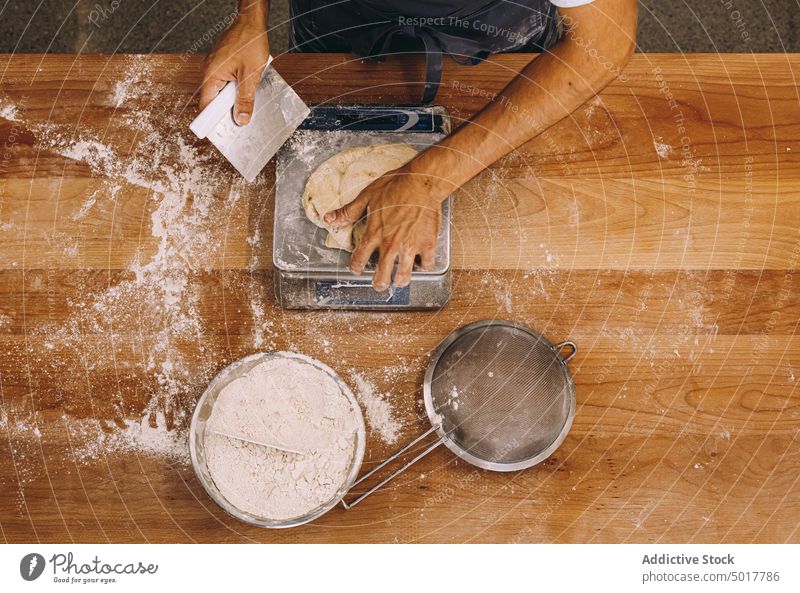 Crop male cook weighing dough bakery weight man bakehouse raw scale process bread prepare wooden table kitchen culinary fresh cuisine ingredient flour guy