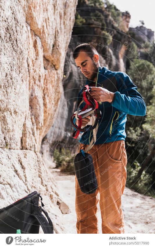 Climber preparing ropes climber hand hook hands gear safety trust climbing anonymous equipment sport carabiners security mountain strength extreme insurance