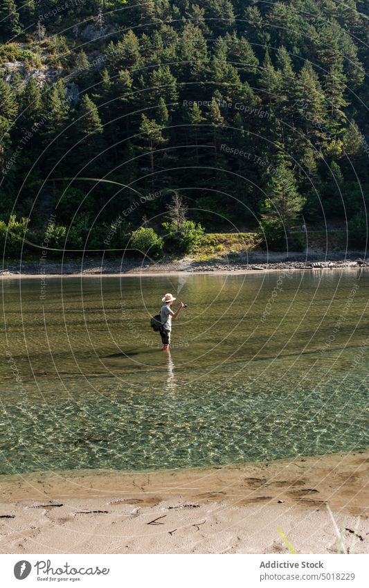 Fisherman man throwing fishing rod into a mountain river fisherman person water recreation sport activity nature catch summer fly hobby lifestyle action male