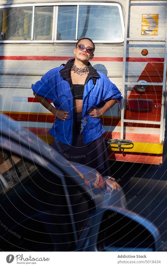 Stylish androgynous man standing near old van queer feminine gay lgbt transgender outfit homosexual male skirt city trendy style urban transport vehicle lgbtq