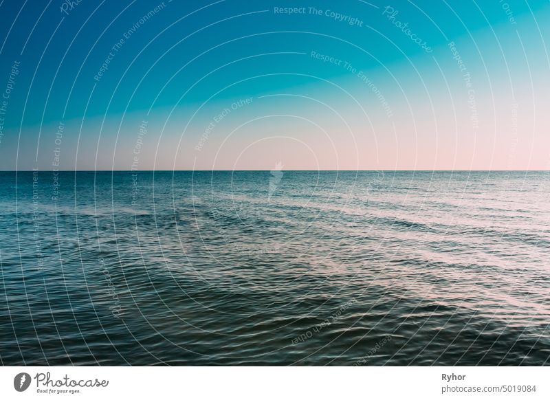 Sunny Blue Clear Sky Over Calm Water Of Sea Or Ocean. Natural Seascape Background landscape clean line blue deep view still water scene ripple abstract color