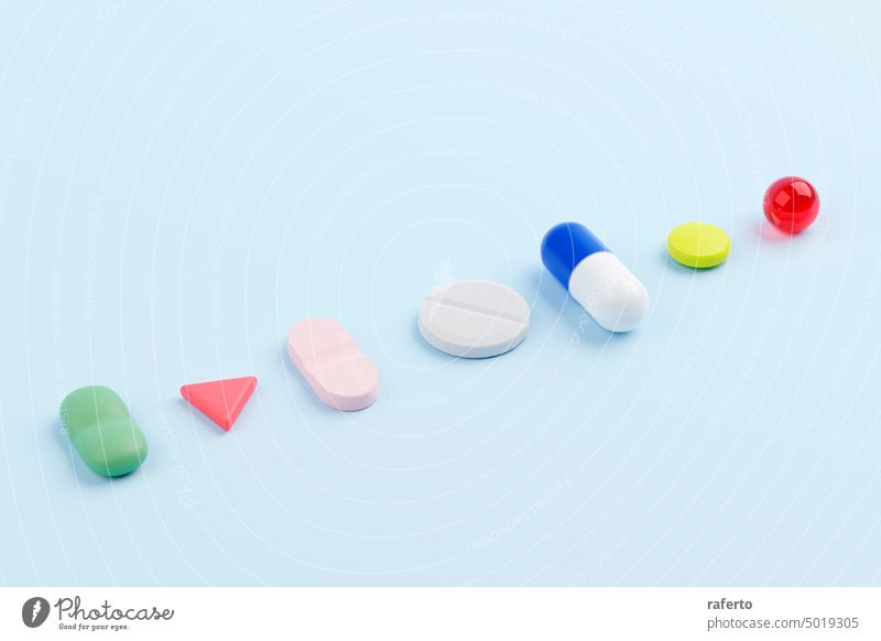 Various pills and medicine on a blue background. Close up 3D render illustration. tablet drug health capsule medical medication vitamin concept pharmacy