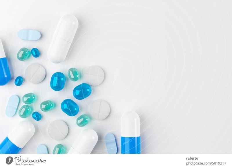 Blue and white medicine capsules and pills on a blue background disease drug tablet antibiotic pharmacy health medicals pharmaceutical vitamin health care