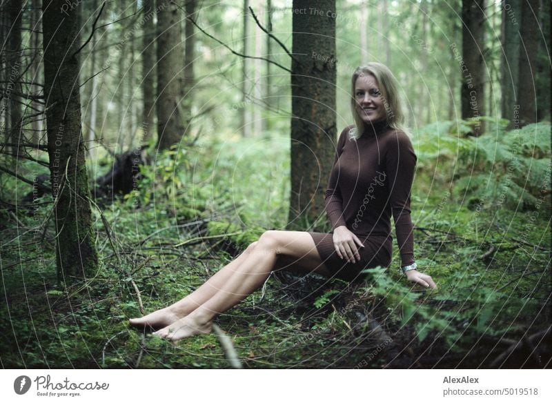Young blonde woman sitting barefoot on fallen tree trunk in forest - analog 35mm photo Young woman Woman Blonde Feminine pretty fortunate Youth (Young adults)