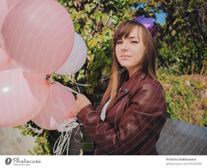 Pretty young teenager in crown with air balloons celebrating birthday. Happy holiday, princess style. background baloon beautiful beauty bright cheerful