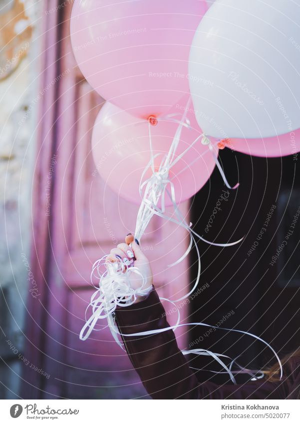 Hand with colorful white and pink balloons. Birthday girl, holiday celebrating, congratulations. background baloon beautiful beauty birthday bright cheerful