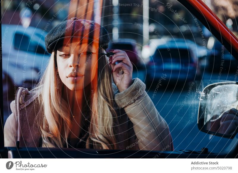 Ethnic female applying makeup near car woman wing mirror mascara african american young city street reflection ethnicity black vehicle modern contemporary style