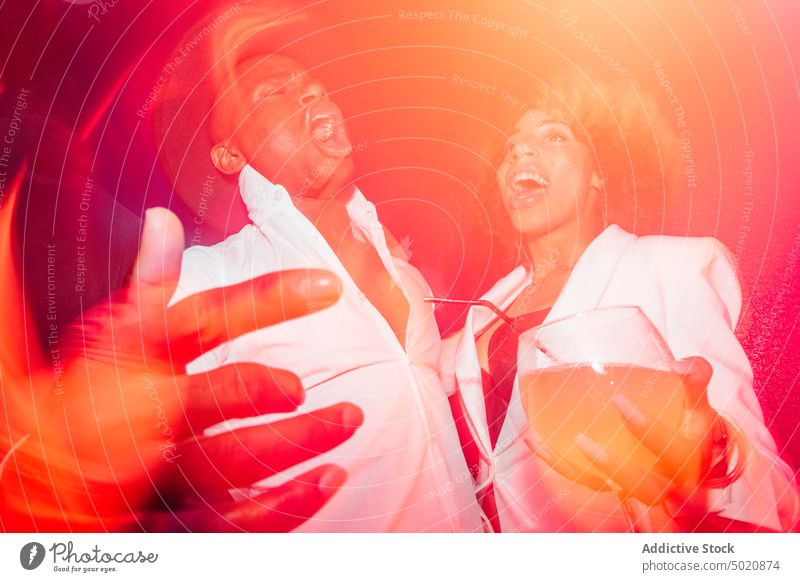 Black couple screaming during party dance nightclub red light ethnic cocktail drunk fun man woman alcohol beverage drink celebrate festive event happy joy relax