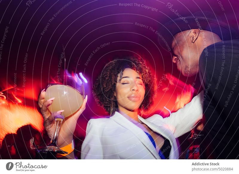 Black couple dancing under colorful light dance fun party nightclub scream ethnic illuminate neon man woman yell shout black african american nightlife bright
