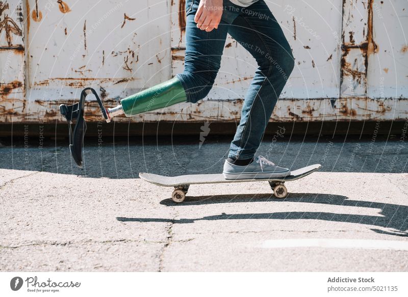 Man with artificial leg riding skateboard man ride determination motivation dynamic wall street amputee city exterior young concrete energy urban male