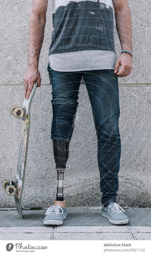 anonymous Young skater with artificial leg on street man skateboard motivation urban power lifestyle town pavement city young wall building confident strong