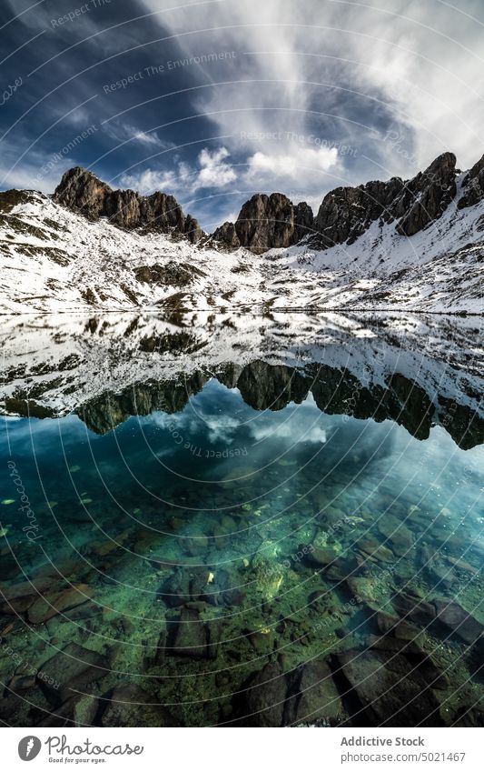 Snowy mountains and crystal lake landscape rock snow reflection nature peak cold en