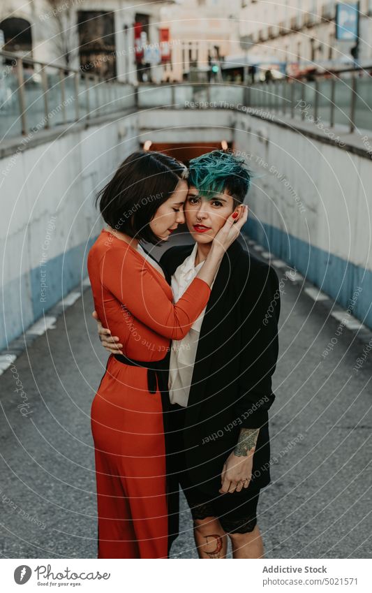 Young stylish ladies embracing on street lesbian couple piercing tattoo love young romantic relationship female adult girlfriend lifestyle lovers passion