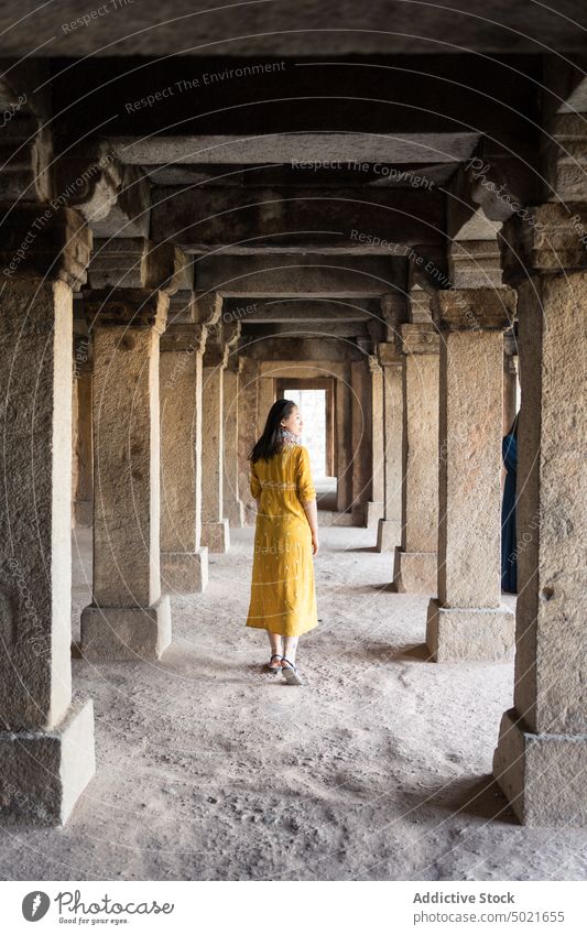 Female traveler walking inside stone building woman old column village explore tourist hauz khas new delhi india female wall architecture ancient aged landmark