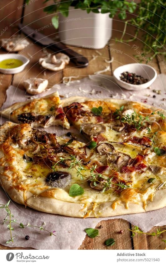delicious pizza with basil and tomato sauce placed on wooden table in kitchen tasty mushroom food yummy fresh lunch cuisine culinary ingredient nutrition dish