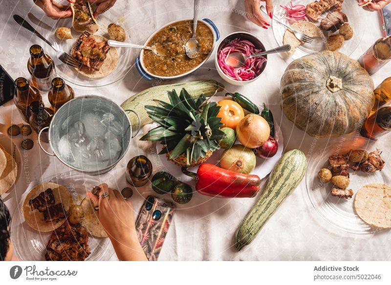 Crop group of friends having barbecue party gather people eat celebrate together food tasty company picnic alcohol meal enjoy beverage dish table delicious
