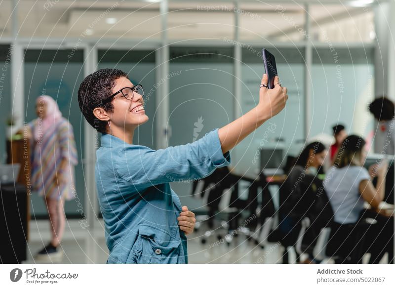 Happy Hispanic female taking selfie in office woman smartphone cheerful gadget smile entrepreneur using device style hispanic ethnic happy mobile modern