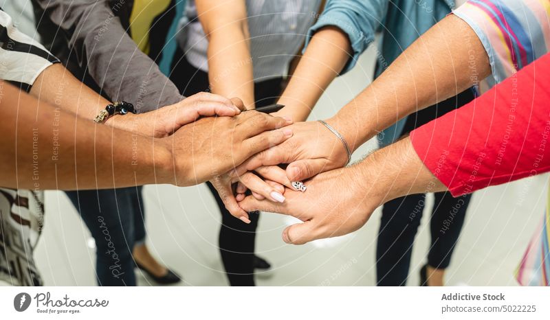 Multiethnic colleagues putting hands together in office people team positive coworker teamwork holding hands gather cooperate diverse multiethnic multiracial