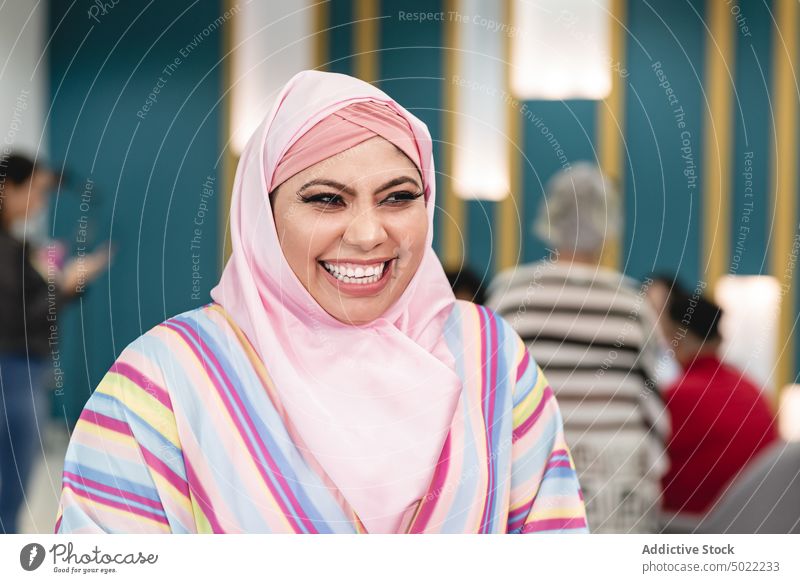 Muslim woman standing in modern workspace positive cheerful smile using gadget job female muslim optimist occupation workplace ethnic costa rica america usa