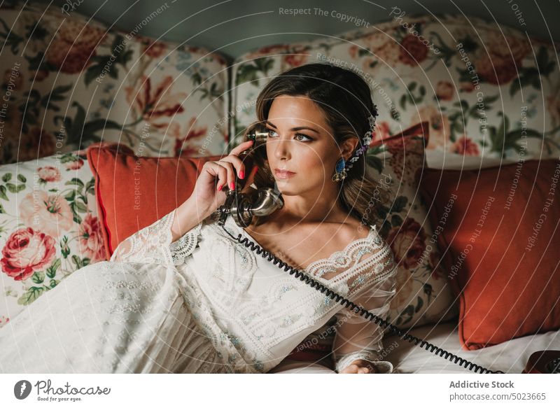 Bride talking on phone bride woman vintage relaxed lying bed attractive wedding makeup lady young beautiful chilling female blouse wear eyelashes curly beauty