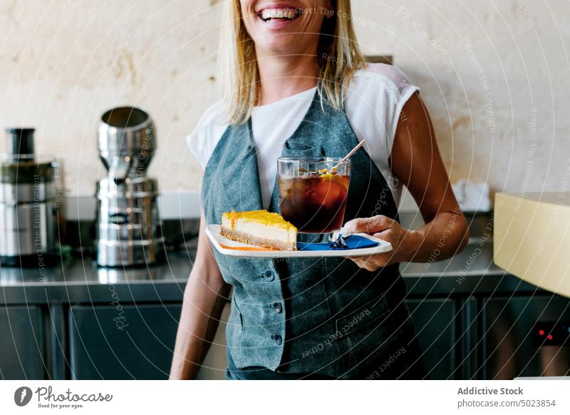 Woman carefully carrying a piece of yellow cake sweet pastry cafe seller woman food dessert bakery fresh tasty restaurant cafeteria occupation snack person