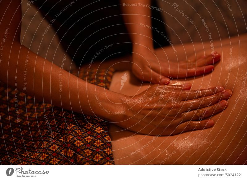 Hands of masseur spreading massage oil to a client woman hands massaging sweat thai massage massagist anonymous treatment therapy asian spa body wellness care