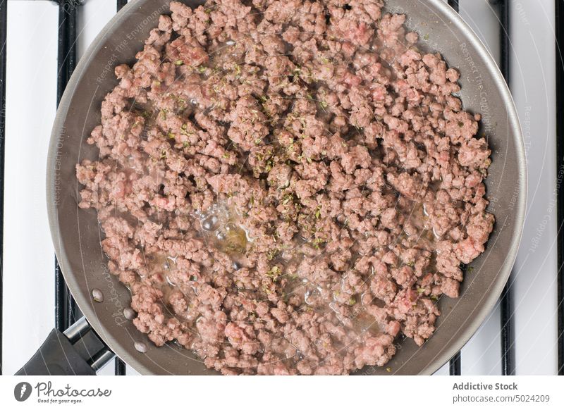 Ground meat frying on pan on stove ground meat raw beef condiment kitchen cook nutrition ingredient prepare recipe delicious spice seasoning appliance nutrient