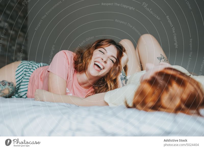 Women With Tattoos Resting On Bed bed bedroom indoors woman pillow alternative anonymous art bedding comfort couple cozy crop faceless female friend friendship