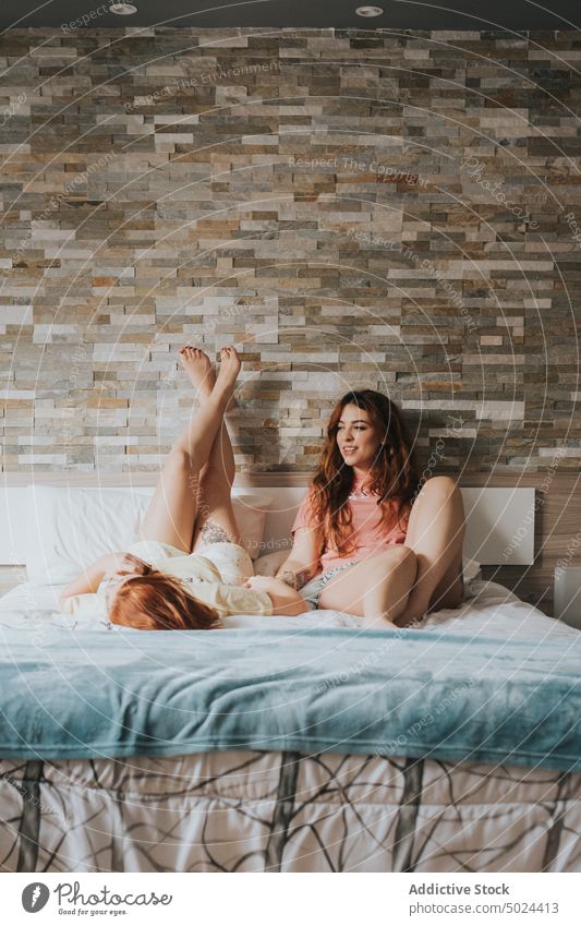 Women With Tattoos Resting On Bed bed bedroom indoors woman leisure home alternative anonymous art bedding comfort couple cozy faceless female friend friendship